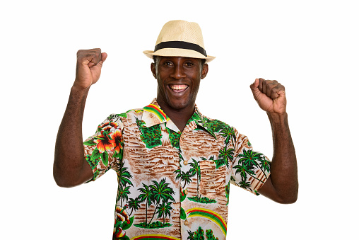 Young happy black African tourist man smiling and looking excited horizontal shot