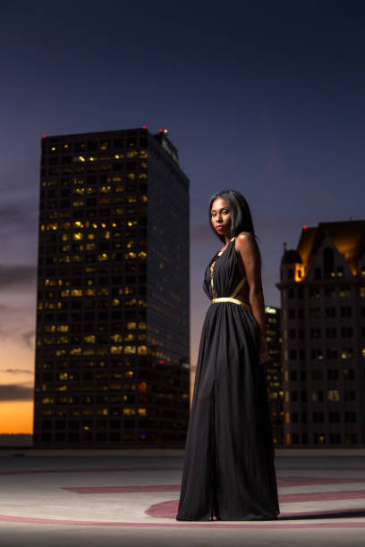 istock Beautiful Woman Standing With Hands Behind Back on Rooftop Helipad 668745666