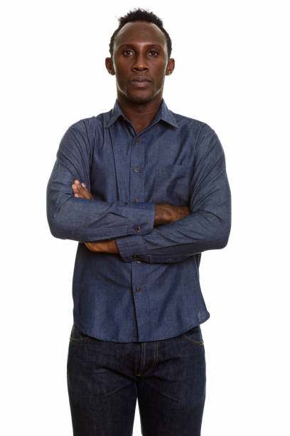 istock Young black African man standing with arms crossed 668746158