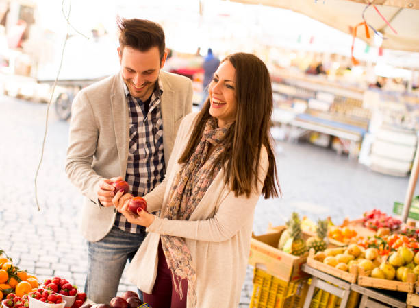 istock Young couple buying vegetables on a market 668751470