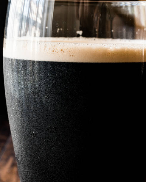 istock Dark Beer on wooden surface. Close up view. 668751556