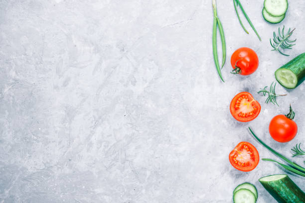 istock Fresh cucumber and tomato on concrete 668751762
