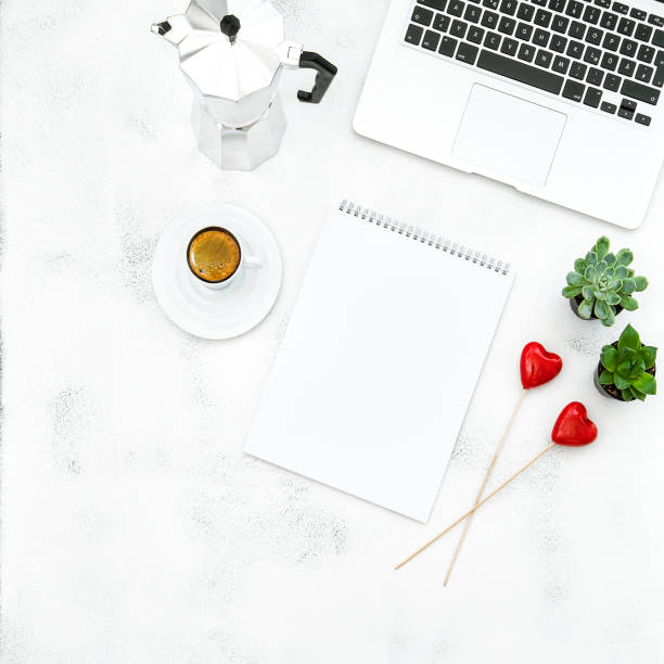 istock Laptop coffee open book red hearts Home office workplace Flat lay 668758440