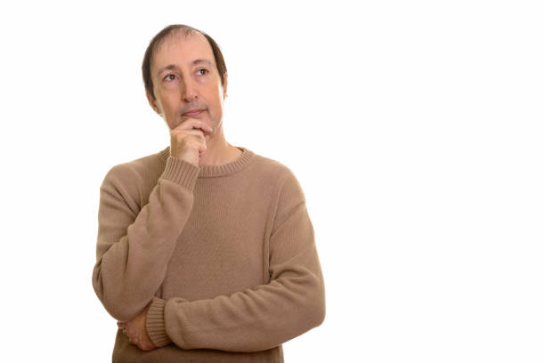 Studio shot of mature man thinking with hand on chin horizontal shot