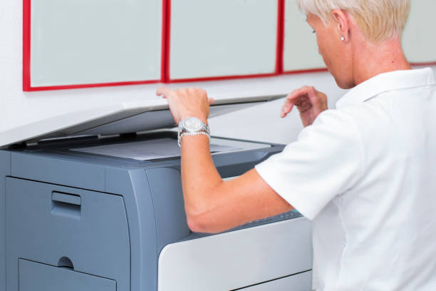 istock Nurse at work...using photocopier,copiing medical results 668760924