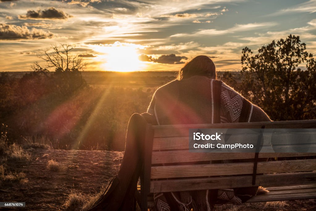Sunset mesa music Relaxing on the mesa with guitar and song. High desert of eastern Arizona. American Southwest. One Woman Only Stock Photo