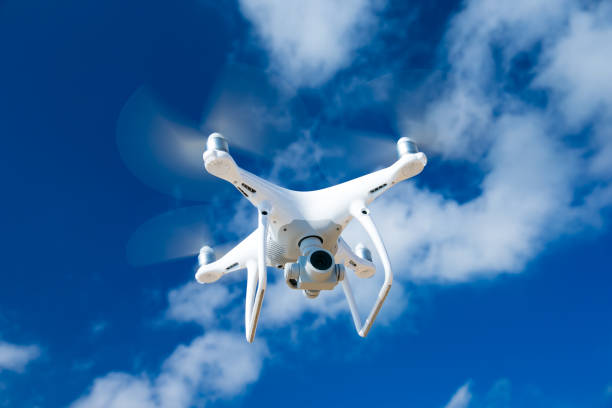 istock drone flying over sea. white drone hovering in a bright blue sky 668766928