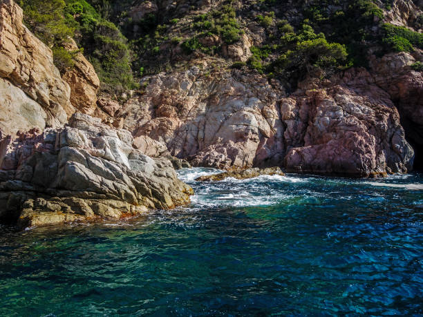 istock The sea splashing on the rocks 668767608