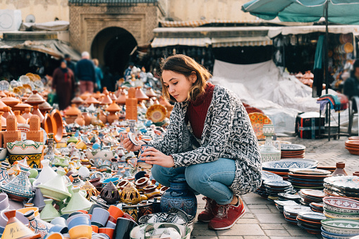 Young Caucasian woman choosing Ceramic  in shop in Meknes, Morocco