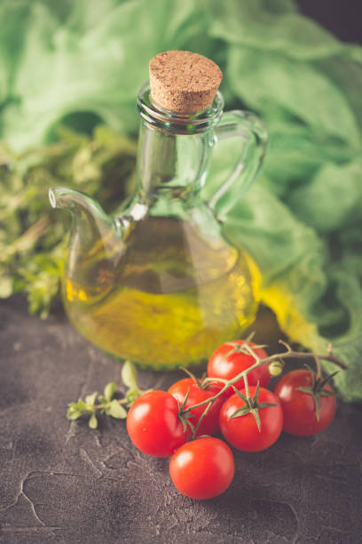 istock Bottle with vegetable oil and cherry tomatoes 668777616