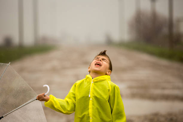 istock A young boy outside in the rain 668779808