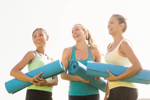 istock Laughing sporty women with exercise mats 668793190
