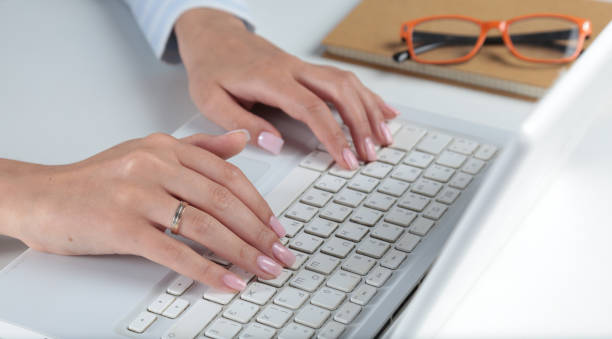 istock Woman working on laptop, sitting at the desk 668808042