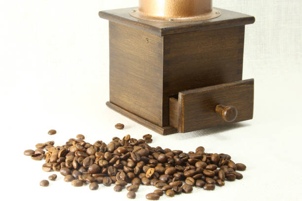 istock coffee grinder and coffee bean on white background. 668808628