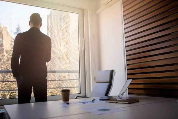 istock Businessman standing near the window 668811690