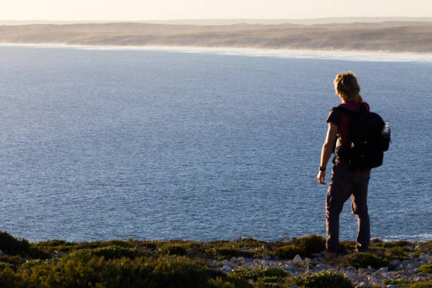 A Hiker Looks at the Coastal View Ahead stock photo