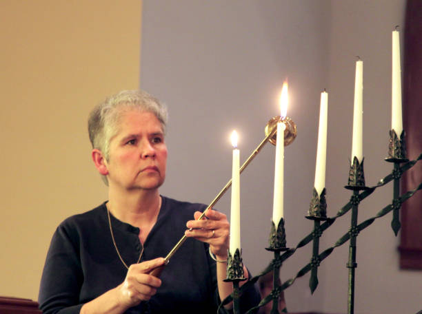 istock Candlelighter At An Evening Church Service 668817838