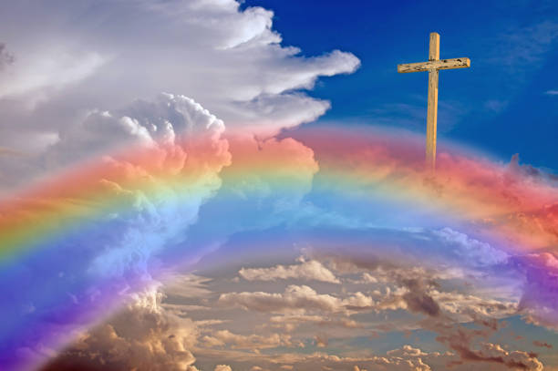 istock A wood cross in clouds with rainbow 668820092