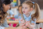 Teacher helps young student with math