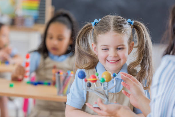 istock Confident young schoolgirl at school 668824738