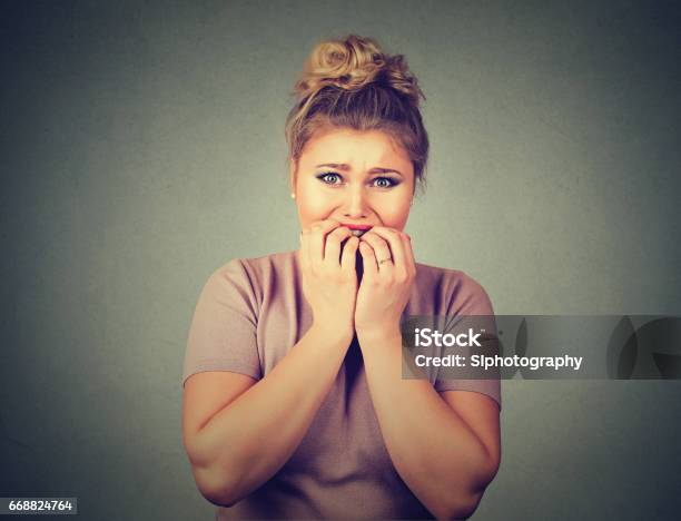 Nervous Stressed Young Woman Student Biting Fingernails Looking Anxiously Craving Something Stock Photo - Download Image Now