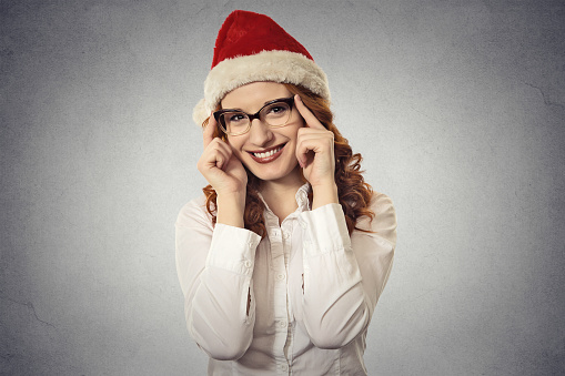 Portrait beautiful young christmas girl wearing santa claus clothes isolated on grey wall background. Positive face expression, emotion, feelings. Holiday season sale concept