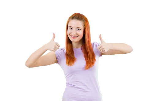 Closeup portrait pretty friendly pleased young smiling, redhead woman giving two thumbs up at camera sign isolated white background. Positive human emotions, facial expression, feelings. Symbol, signs