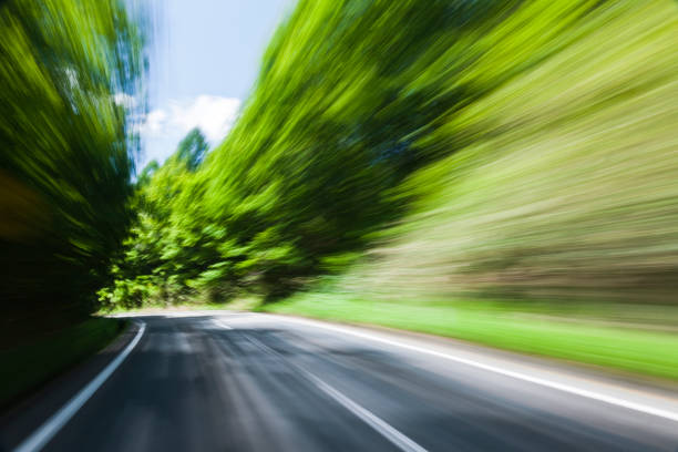 istock Car Driving Through Forest Road 668831644