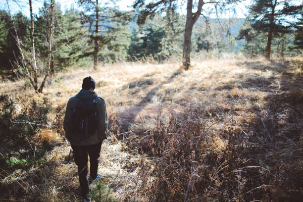 istock Young man walking in nature 668843054