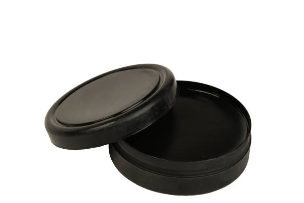 black shoe polish lid ajar on a white background black shoe polish lid ajar on a white background shoe polish stock pictures, royalty-free photos & images