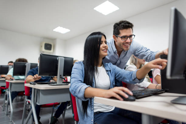 istock Female student in an IT class asking teacher a question 668843274