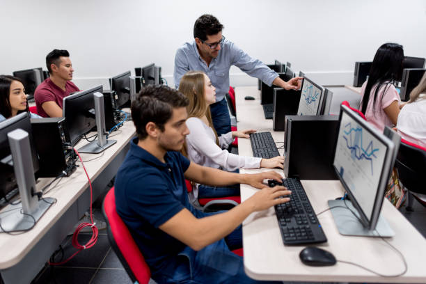istock Teacher with a group of students in an IT class at the school 668843304