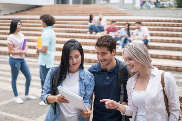 istock Happy group of students at the university 668843400