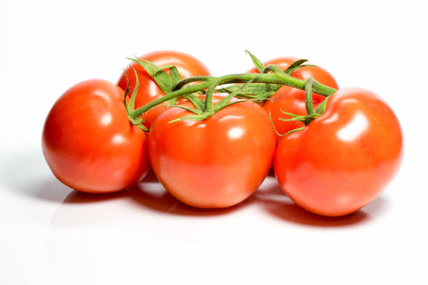 istock Bunch of fresh red tomatoes isolated on white background. 668843600