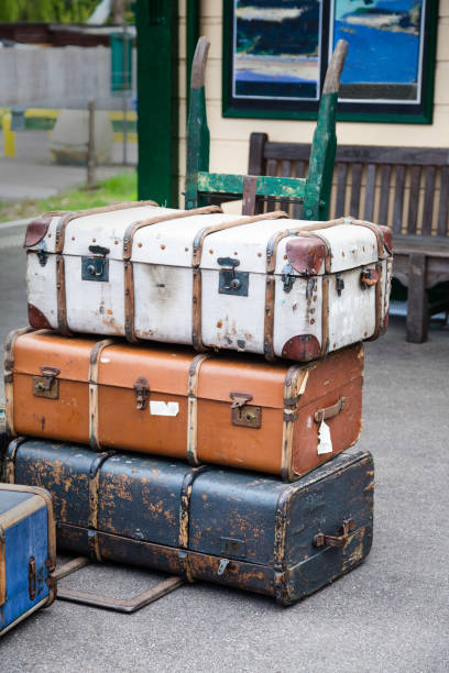 istock old-fashioned luggage and carrier on railway platform 668843798