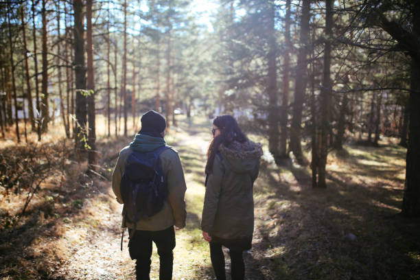 istock Young people walking in the forest 668849402