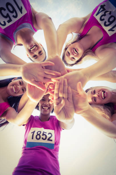 istock Five smiling runners supporting breast cancer marathon 668850130
