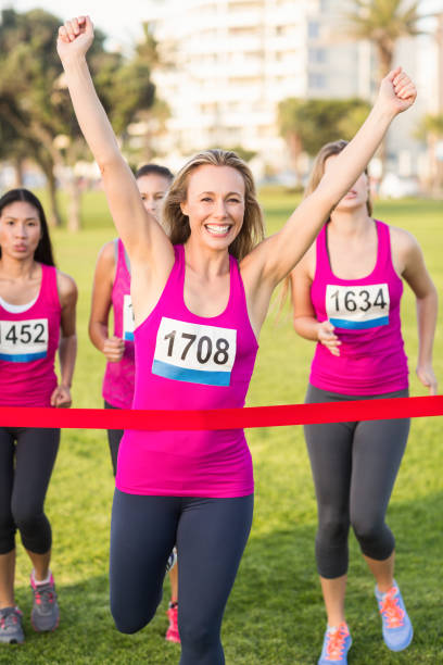 istock Cheering blonde winning breast cancer marathon 668850328