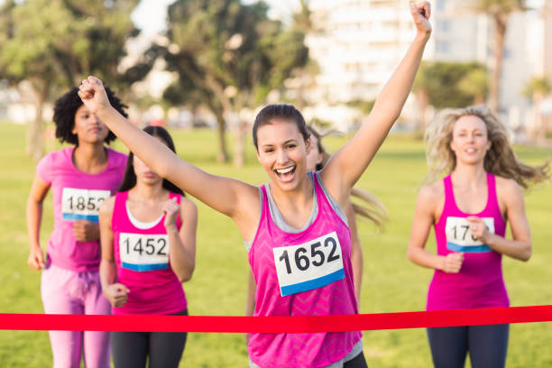 istock Cheering brunette winning breast cancer marathon 668850530