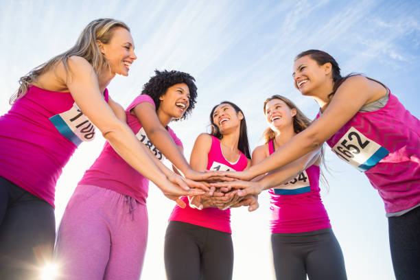 istock Five smiling runners supporting breast cancer marathon 668852752