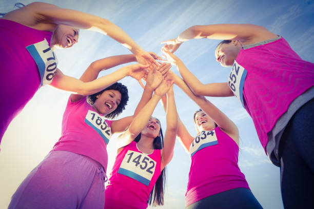 Five cheering runners supporting breast cancer marathon in parkland