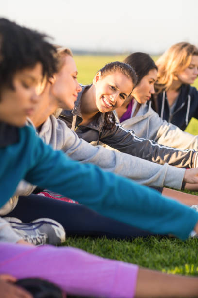 istock Smiling sporty brunette stretching during fitness class 668860814
