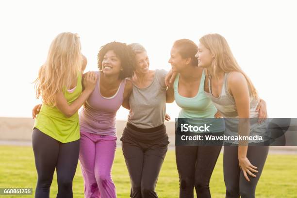 Smiling Sporty Women With Arms Around Each Other Stock Photo - Download Image Now - Women, Exercising, Only Women