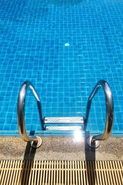 istock Swimming pool with stair and blue relaxing water 668866858