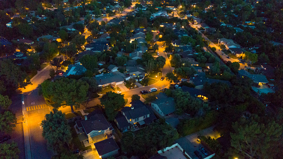 An aerial photograph of a residential neighborhood at night.
