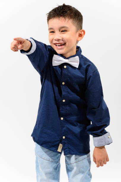 istock Studio shot of cute happy boy smiling and laughing while pointing finger 668881700