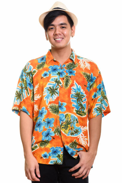 istock Young happy Asian tourist man smiling and standing while wearing hat 668888836
