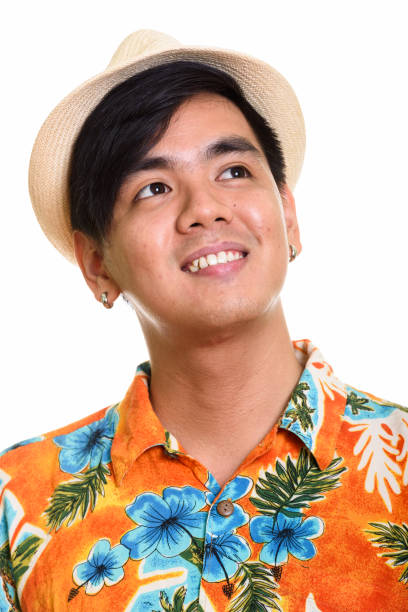 istock Face of young happy Asian tourist man smiling while thinking 668888934
