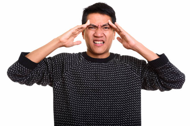 istock Studio shot of young Asian man having headache 668894598