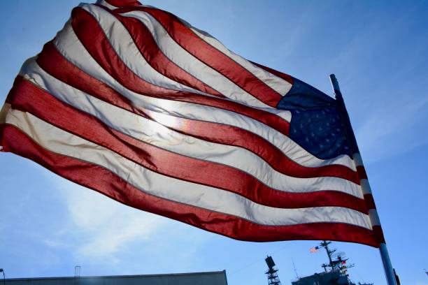 istock American flag flutters in the ocean breeze. 668894614